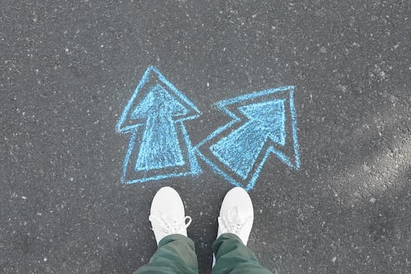 Someone standing on chalk drawn arrows